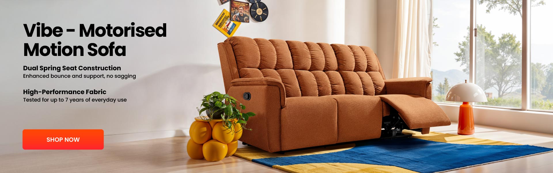 Brown motorised motion sofa in a living room with decorative items and a large window.