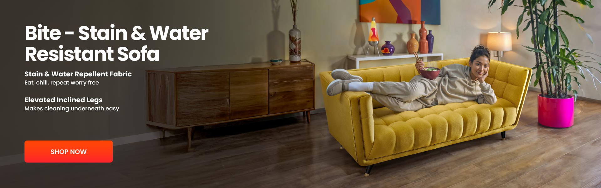 Yellow sofa with a woman lounging on it, surrounded by decor items in a living room setting.