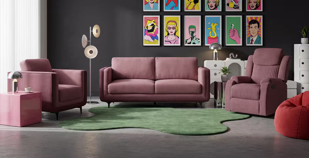 Modern living room with pink sofa, armchairs, and colorful artwork on the wall.