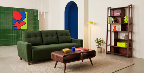 Modern living room with a green sofa, wooden coffee table, and bookshelf.